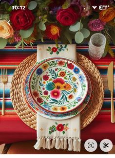 an image of a table setting with flowers on the plate and place settings below it