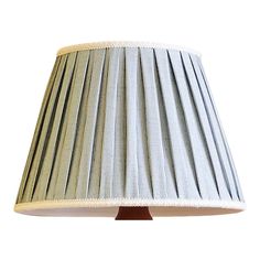 a pleated lamp shade is shown against a white background with light brown stripes on the bottom