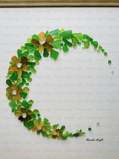 green and yellow flowers are arranged in the shape of a circle