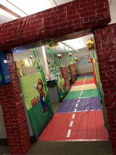 the entrance to an office decorated with paper machs and mario's birthday decorations