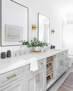 a bathroom with two sinks and mirrors on the wall next to a rug in front of it