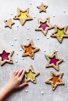 hand reaching for star shaped cookies on table