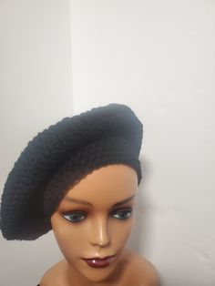 Add some color to your casual outfits with this handmade black crochet beret tam beanie. Made from lightweight and breathable acrylic material, this hat is perfect for all seasons. The beanie features accents of crochet and is adorned with a reggae-themed design that is sure to turn heads. This one-size-fits-all beanie is an ideal addition to your wardrobe if you are a fan of reggae or rastafarian culture. It has stretchy fabric that ensures a comfortable fit and is suitable for both men and women. With no tags attached, this beanie is like new and ready to be worn to any casual occasion. Black Acrylic Beanie, Trendy Black Crochet Hat, Black Slouchy Crochet Beanie Hat, Black Acrylic Yarn Beanie Cap, Adjustable Black Crochet Hat Trendy Style, Slouchy Black Crochet Beanie, Trendy Adjustable Black Crochet Hat, Trendy Black Adjustable Crochet Hat, Black Acrylic Yarn Beanie