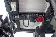 the inside of a vehicle with its door open and phone hooked up to it's center console