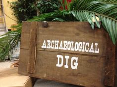 a wooden box with the words archaeological dig written on it