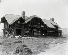 an old log house is shown in this black and white photo