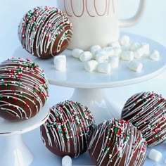 there are chocolate covered strawberries and marshmallows on the cake stand