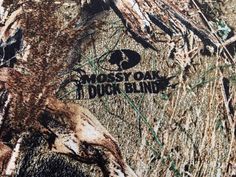 the moss out duck blind logo is shown on this camo shirt, which has been worn