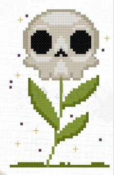 a cross stitch pattern with a skull on it's face and a flower in the middle