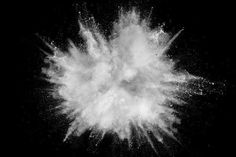 white powder exploding in the air on a black background