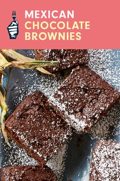 mexican chocolate brownies with powdered sugar on top and corn in the foreground