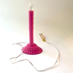 a pink light is plugged into a cord