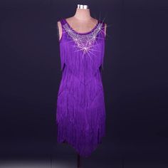 a purple dress with fringes and beads on it