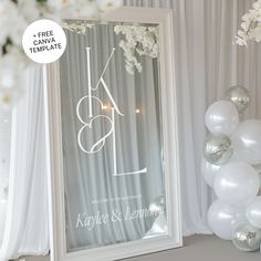 a white framed mirror sitting on top of a table next to balloons and streamers