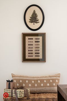 a living room with a couch, coffee table and christmas tree hanging on the wall