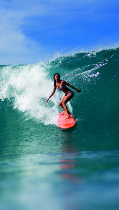 a woman on a surfboard riding a wave with the words follow your heart and don't