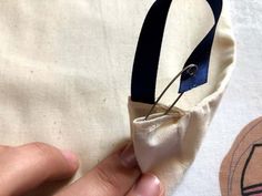 someone is using scissors to sew something on a piece of cloth that has been stitched together