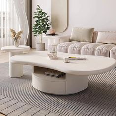 a living room with white furniture and a large mirror on the wall above the coffee table