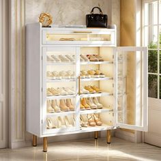 a white cabinet with shoes and purses on it in a room next to a window