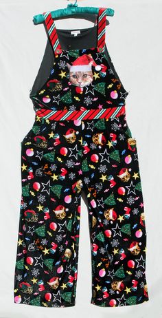 These are the Cat's Meow! Not only for childless cat ladies ;) , this soft stretchy velvety jumpsuit/overalls by "Eyeshadow" is your answer to getting in the Christmas mood, whether you wear it decorating a tree, out caroling, snuggling with your favorite cat, as the Belle of the ever-popular Ugly Christmas Sweater Party, or maybe ALL of the above! It features a cute 3D-stuffed cat face on the front bib, darling Xmas tree buttons on the bib straps, oh-sooo-soft stretchy velvet fabric, and pockets- one on each side at the hip! Size is XL, but please see our detailed measurements below (it may seem close to a women's "L") and base your final decision on these. This is a one-piece jumper that you get into by undoing the straps. The back waist is elasticised, and it is in excellent unworn cond Christmas Overalls, Decorating A Tree, Velvet Jumper, Jumpsuit Overalls, One Piece Jumper, Stuffed Cat, Christmas Sweater Party, Womens Jumpsuits, Ugly Christmas Sweater Party