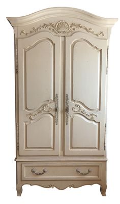 an antique white armoire with ornate carvings on the top and bottom, against a white background