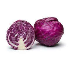 an onion and cabbage cut in half on a white background