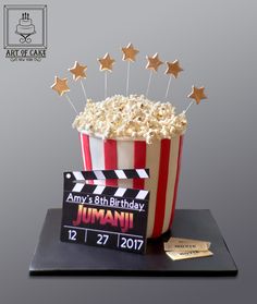 a popcorn bucket with stars on top and a movie ticket