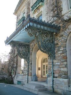 an old stone building with ornate iron work