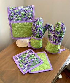 green and purple items sitting on top of a wooden table