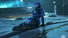 a sci - fi character sitting on the ground in a futuristic setting