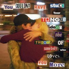 two people hugging each other in front of a window with words all over the place