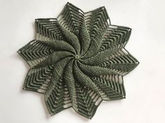 a green flower made out of knitted fabric