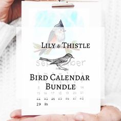 someone holding up a calendar with a bird on it