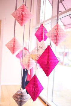 pink and white paper lanterns hanging from the ceiling