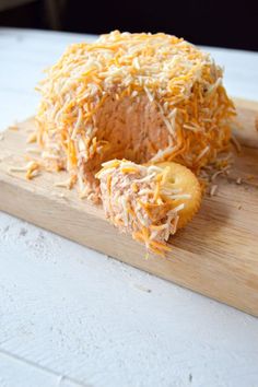 a cheese ball on a wooden cutting board