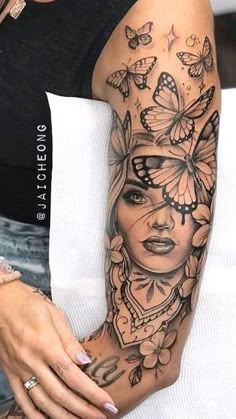 a woman's arm with butterflies on it and a girl in the middle of her arm