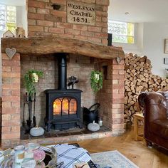 a living room filled with furniture and a fire place in the middle of a fireplace