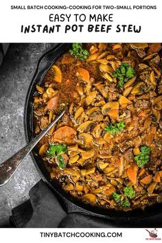 a skillet filled with beef stew and carrots