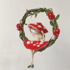 an ornament made to look like a mushroom with leaves and flowers on it