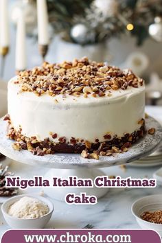 a white cake with nuts on top and the words, nigglela italian christmas cake