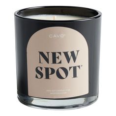 a black candle with the words new spot printed on it's front and side