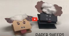 two paper sheeps made out of cardboard boxes