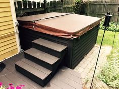 an outdoor hot tub with steps leading up to it