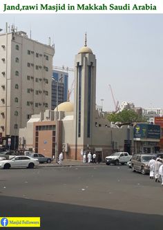 some people are walking around in the middle of a street with cars and buildings behind them