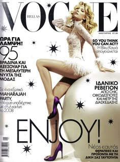 a magazine cover with a woman in high heels on top of a ball and stars