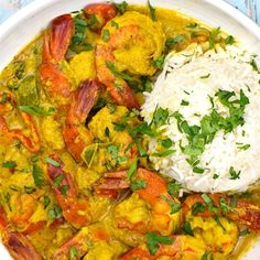 a white plate topped with shrimp and rice