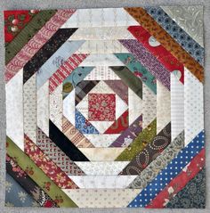 a close up of a quilt with many different colors