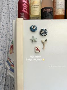 an open refrigerator with magnets and wine bottles