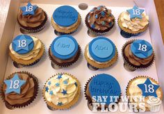 twelve blue and white cupcakes in a box with happy 18th birthday written on them