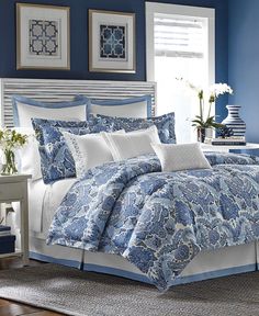 a blue and white bed in a bedroom